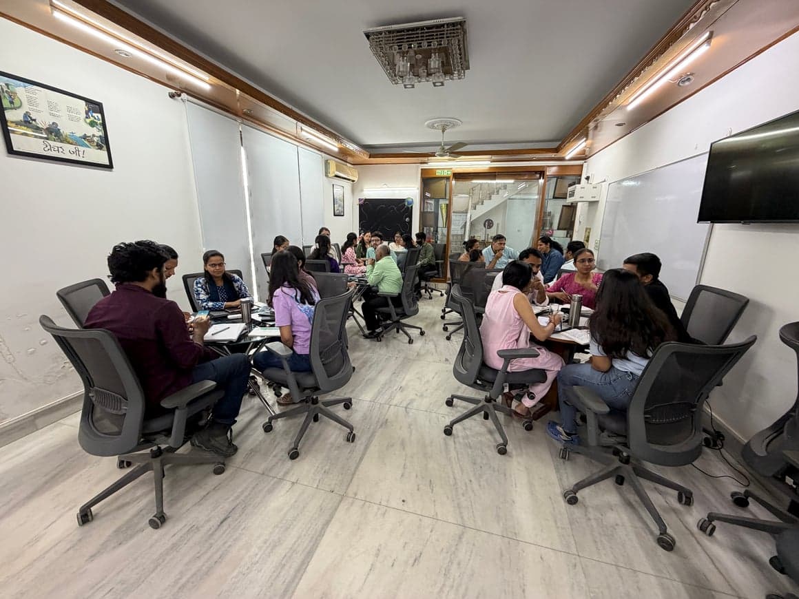 Workshop room wide shot with participants working in groups